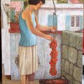 Donna che appende i pomodori